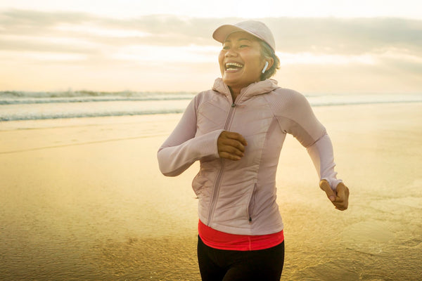 Happy,And,Fit,Middle,Aged,Woman,Running,On,The,Beach