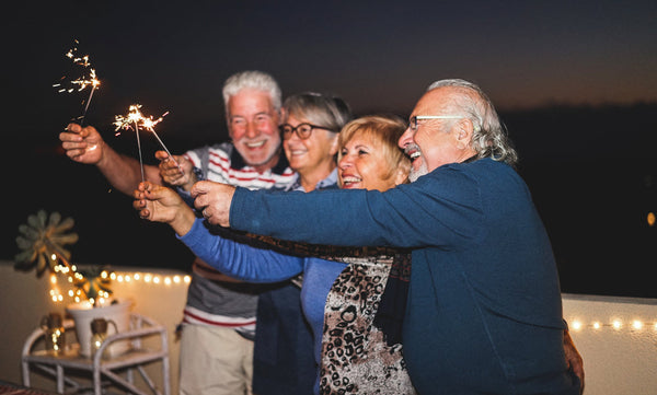 Pensioner,Friends,Having,Fun,With,Fireworks,Sparklers,-,Senior,People||Group,Of,Senior,Looking,In,Camera,For,A,Portrait