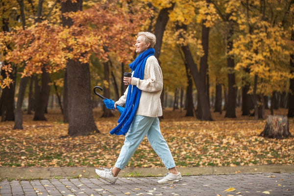 Happy,Beautiful,Middle-aged,Woman,Walking,In,Autumn,Park
